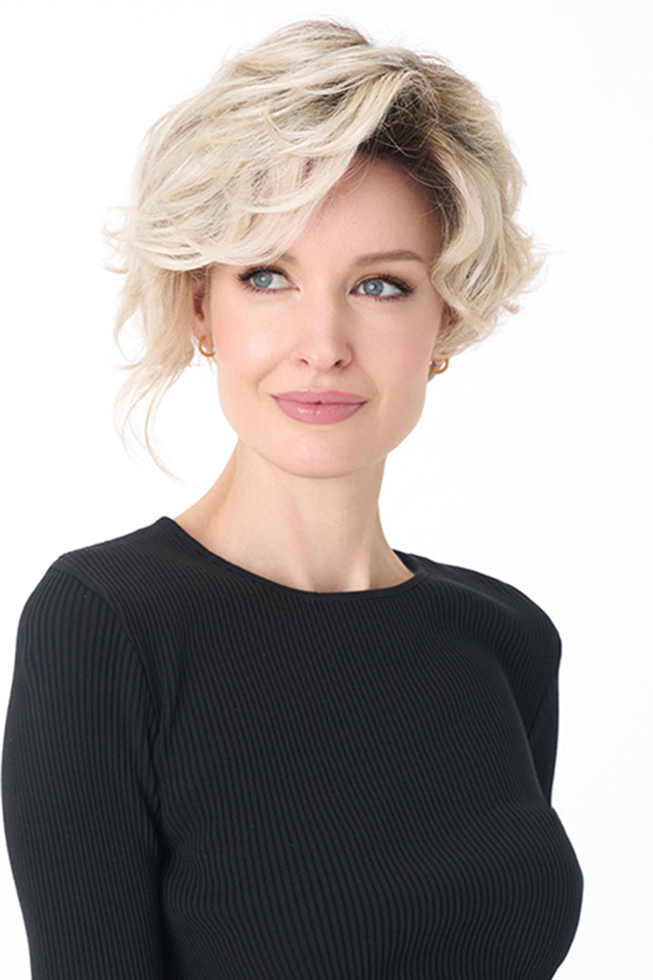 Model wearing a blonde, short-length curly synthetic wig with a natural lace front and monofilament part.
