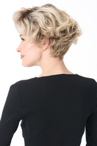 Carrisa by Envy short blonde curly synthetic wig with a natural lace front and tousled layered volume.