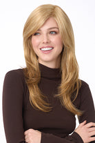 Celeste Large synthetic wig in blonde with long layers, side-swept bangs, and a natural monofilament top.