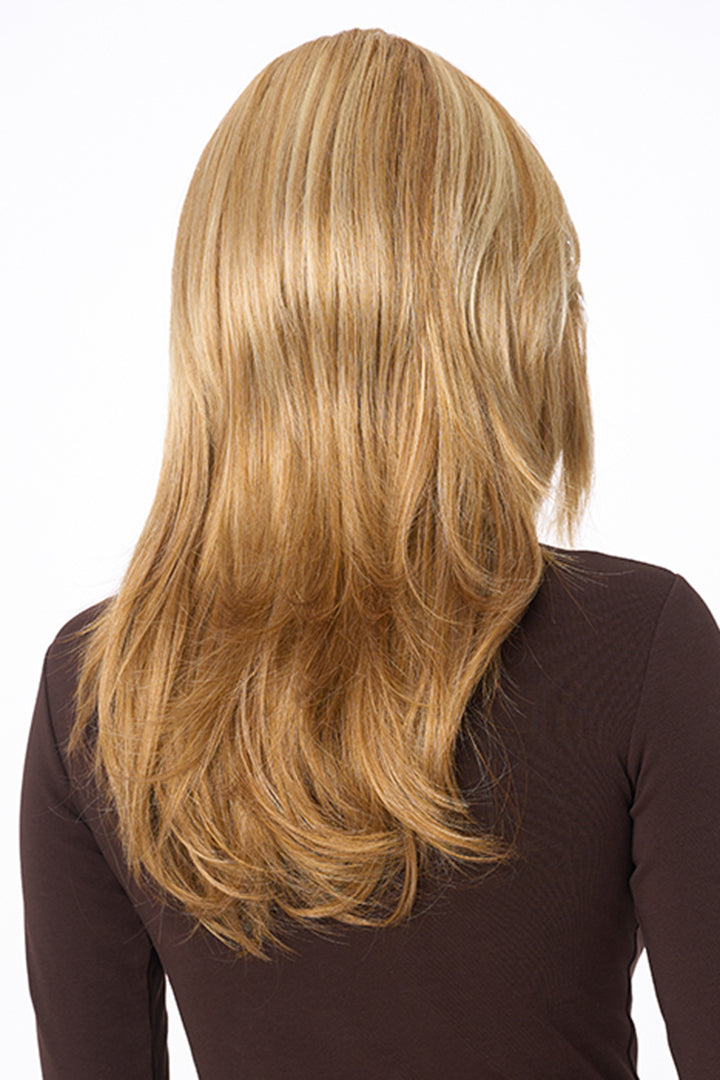 Back view of Celeste Large synthetic wig by Envy featuring long, layered blonde hair with a natural, flowing style.