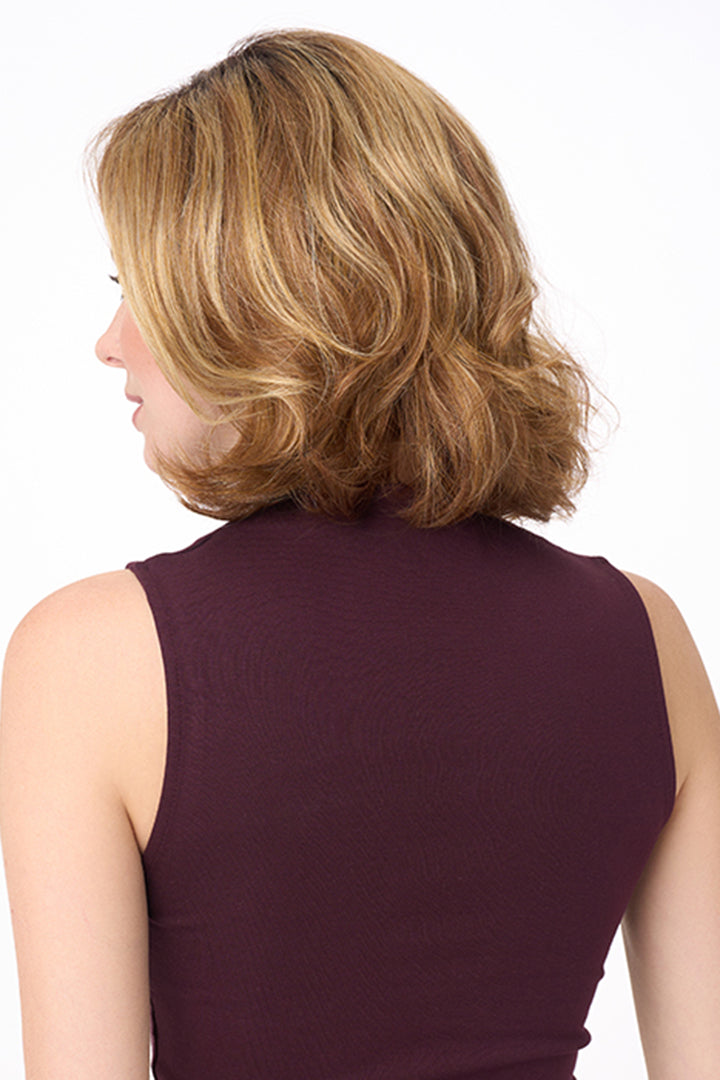 Back view of Chloe by Envy synthetic wavy layered bob wig in blonde highlights with a natural, voluminous finish.