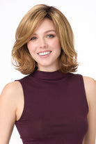 Chloe by Envy synthetic wavy bob wig in a light brown shade with a natural lace front and monofilament part.