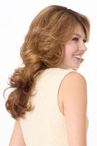 Christine by Envy synthetic wig featuring voluminous, layered light brown hair with a natural monofilament part.