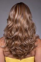 Long wavy HF synthetic wig with blonde money piece highlights, shown from the back.