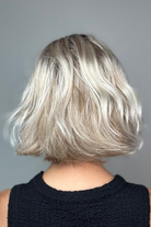 Woman with short blonde bob wig with bangs (Esprit by Ellen Wille in Pearl Blonde R).