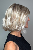 Woman with short blonde bob wig with bangs (Esprit by Ellen Wille in Pearl Blonde R).