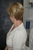 Woman with short blonde pixie wig (Tiffany HT by Envy in Sparkling Champagne)