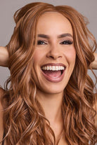 Woman wearing Esme wig by Rene of Paris in Caramel Copper | Smiling