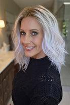 A woman with shoulder-length wavy pink wig (Somers by Estetica in Polarizing Pink).
