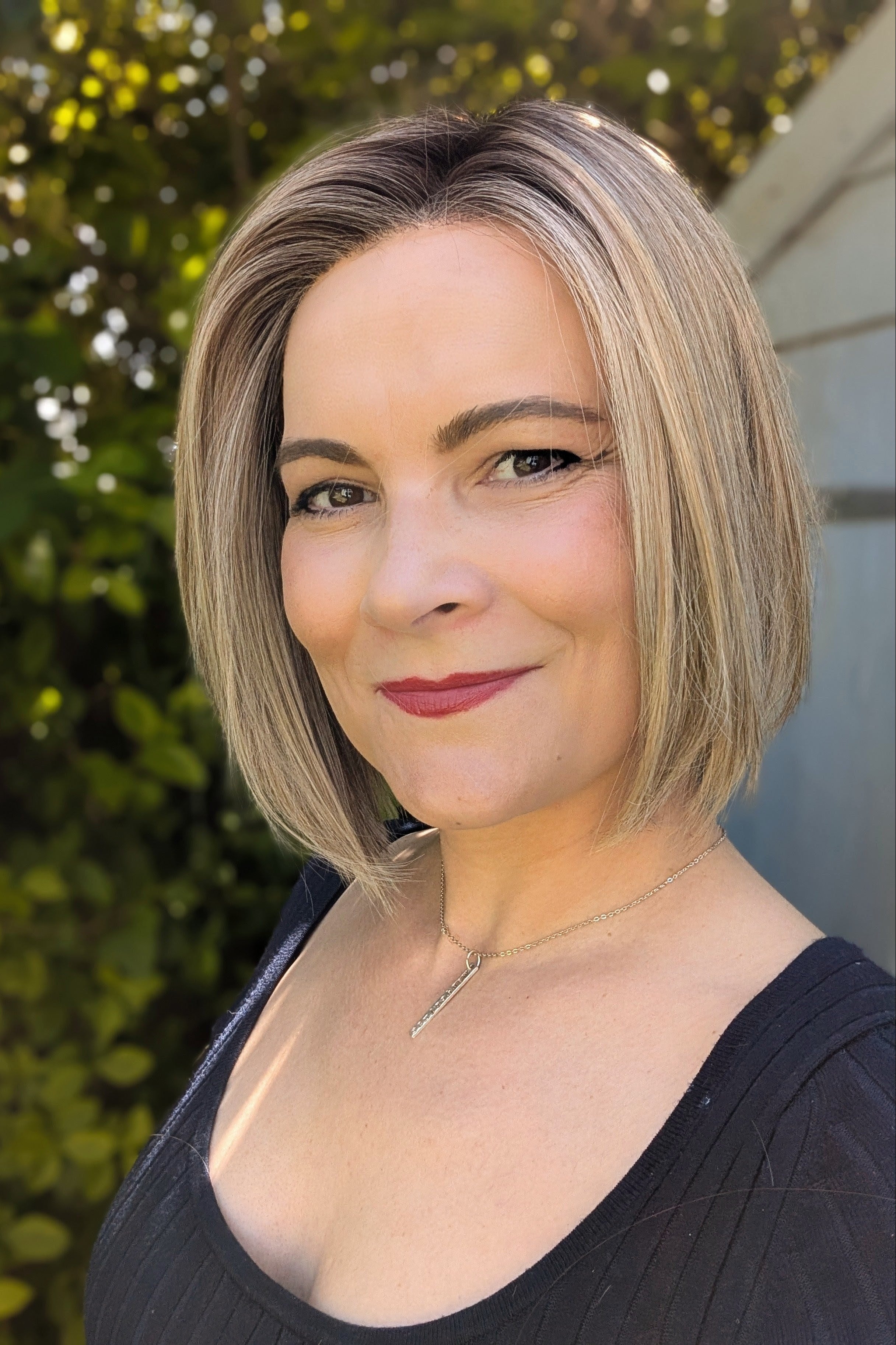 Woman wearing chin-length blonde bob wig (Euro Chic by TressAllure in Cashmere Cream)