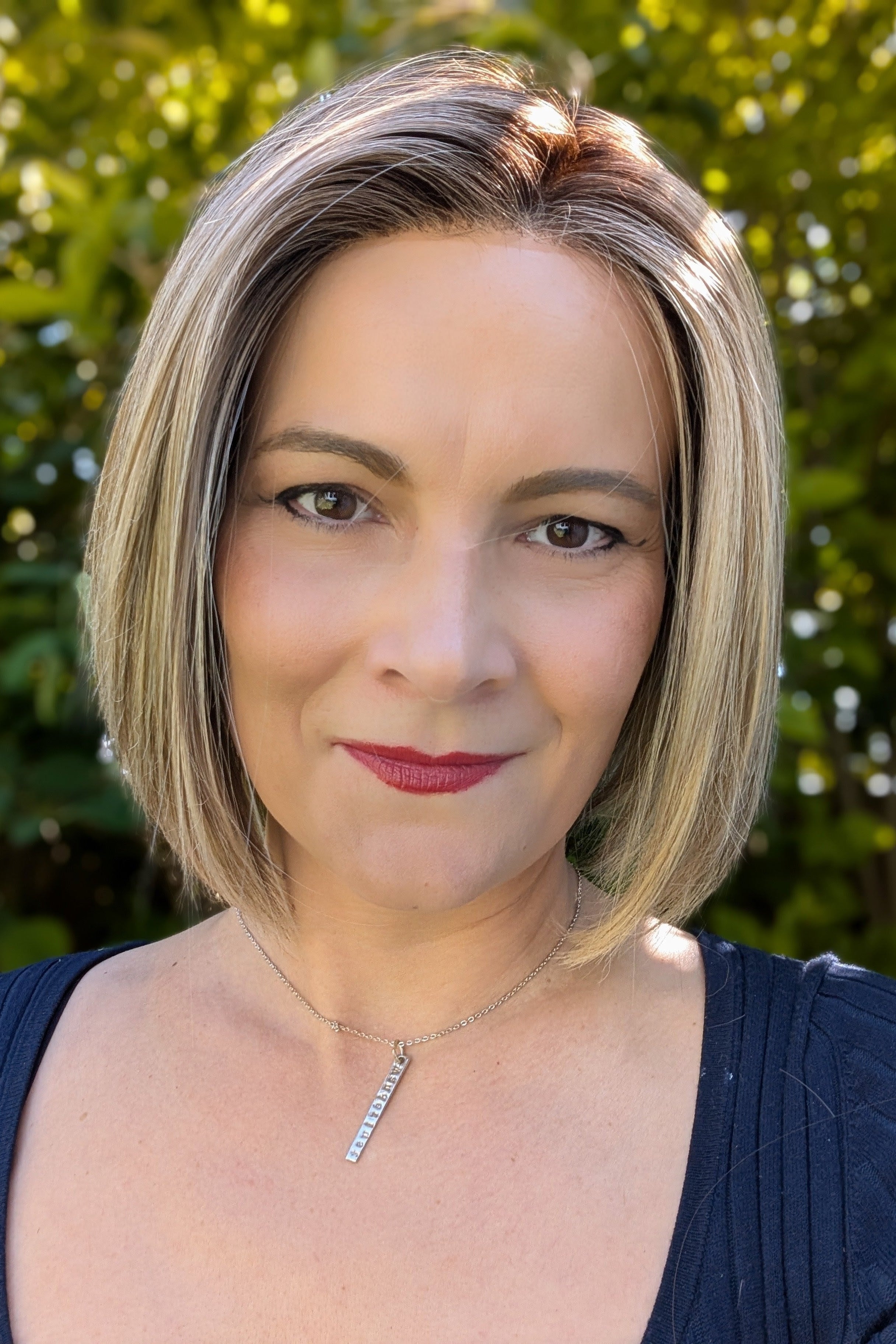 Woman wearing chin-length blonde bob wig (Euro Chic by TressAllure in Cashmere Cream)