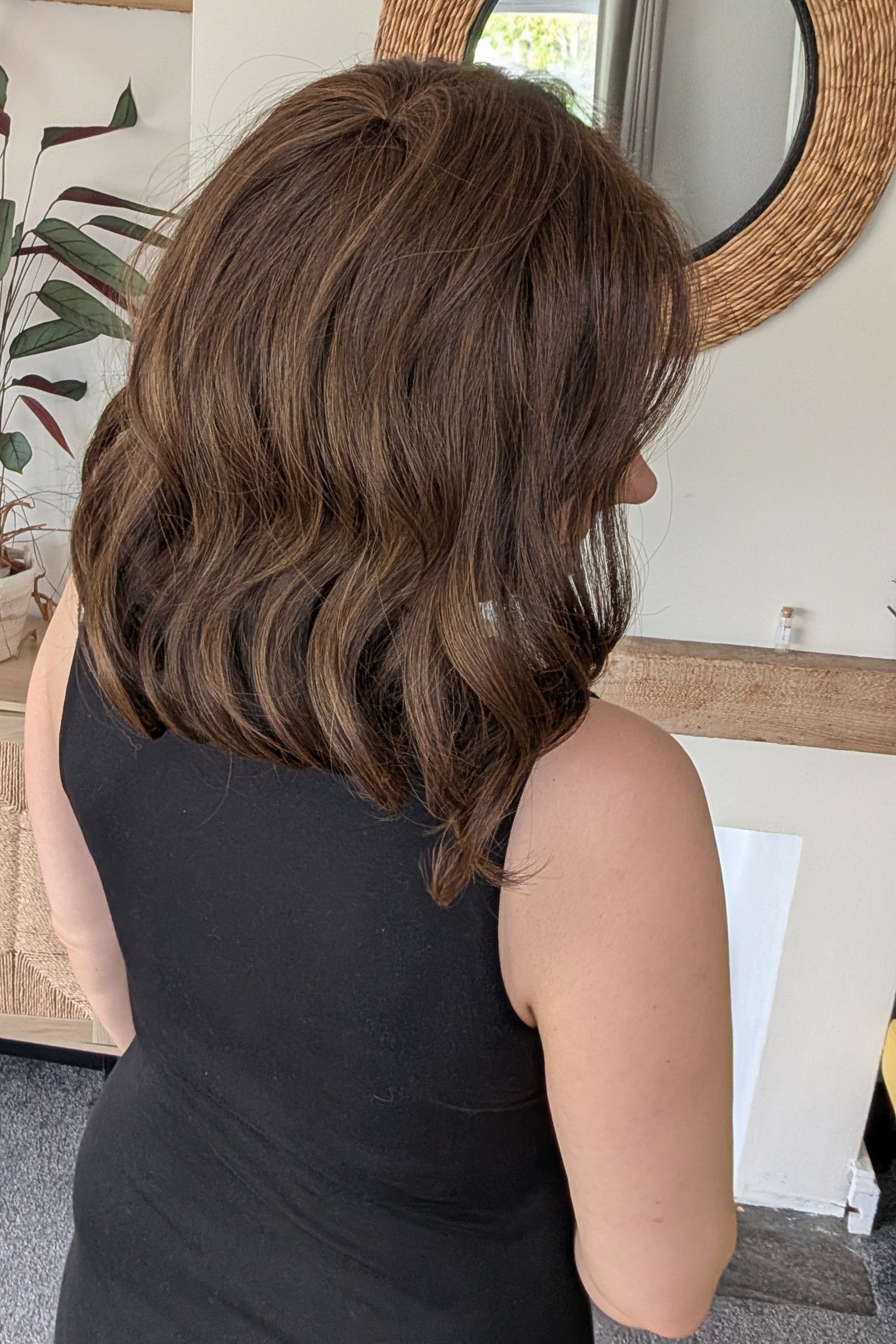 Woman wearing curled bob wig (Exhilaration by Gabor in Light Brown)
