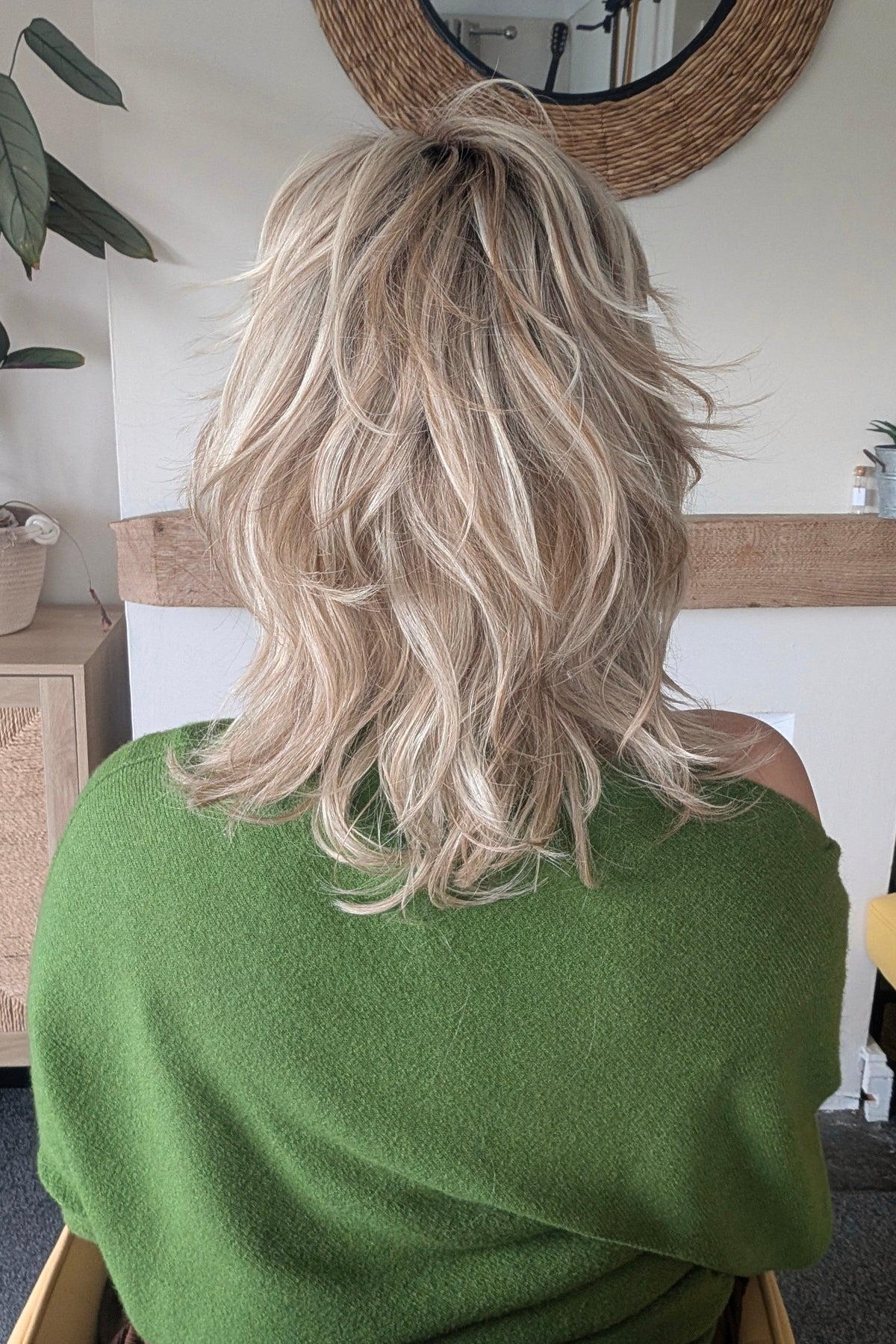 A woman with short blonde layered wig (Farrah by Belle Tress in color Butterbeer-R)