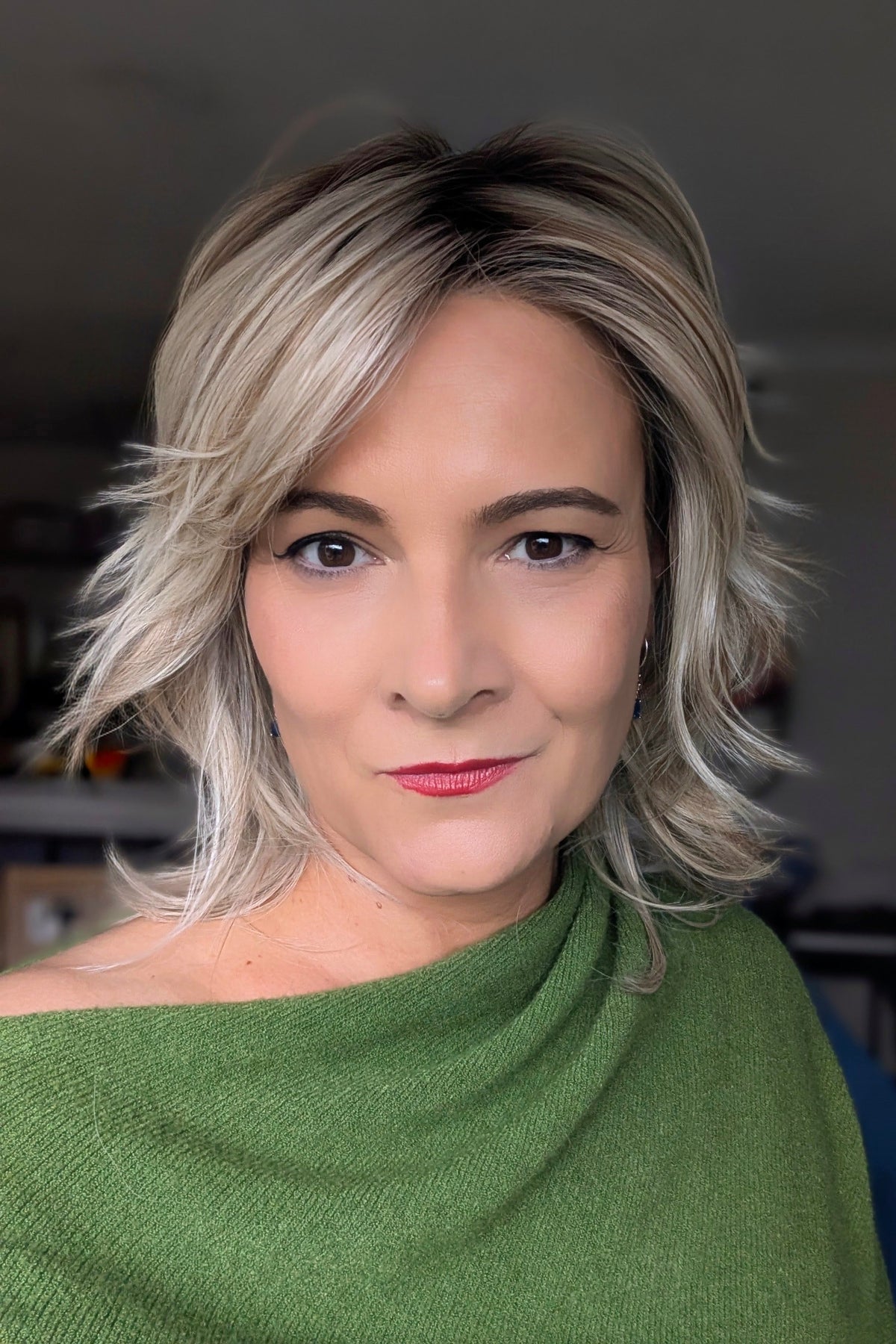 A woman with short blonde layered wig (Farrah by Belle Tress in color Butterbeer-R)