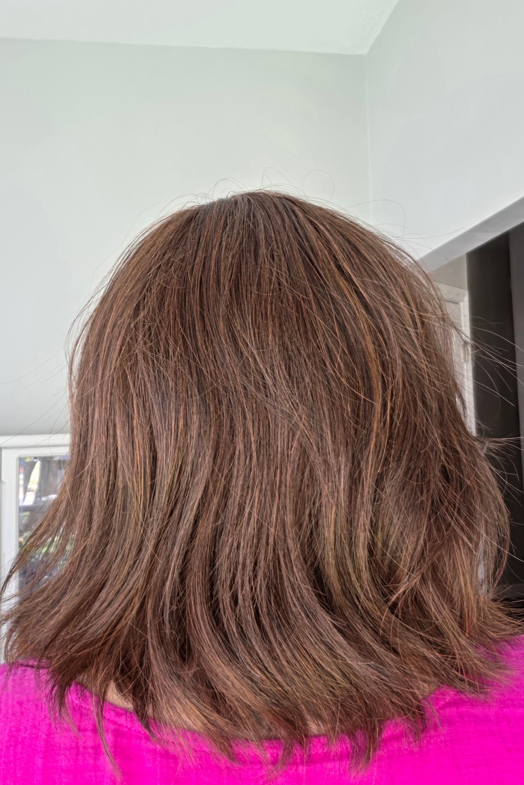 Woman wearing shoulder length wavy bob (Farren by Amore in Ginger Brown).