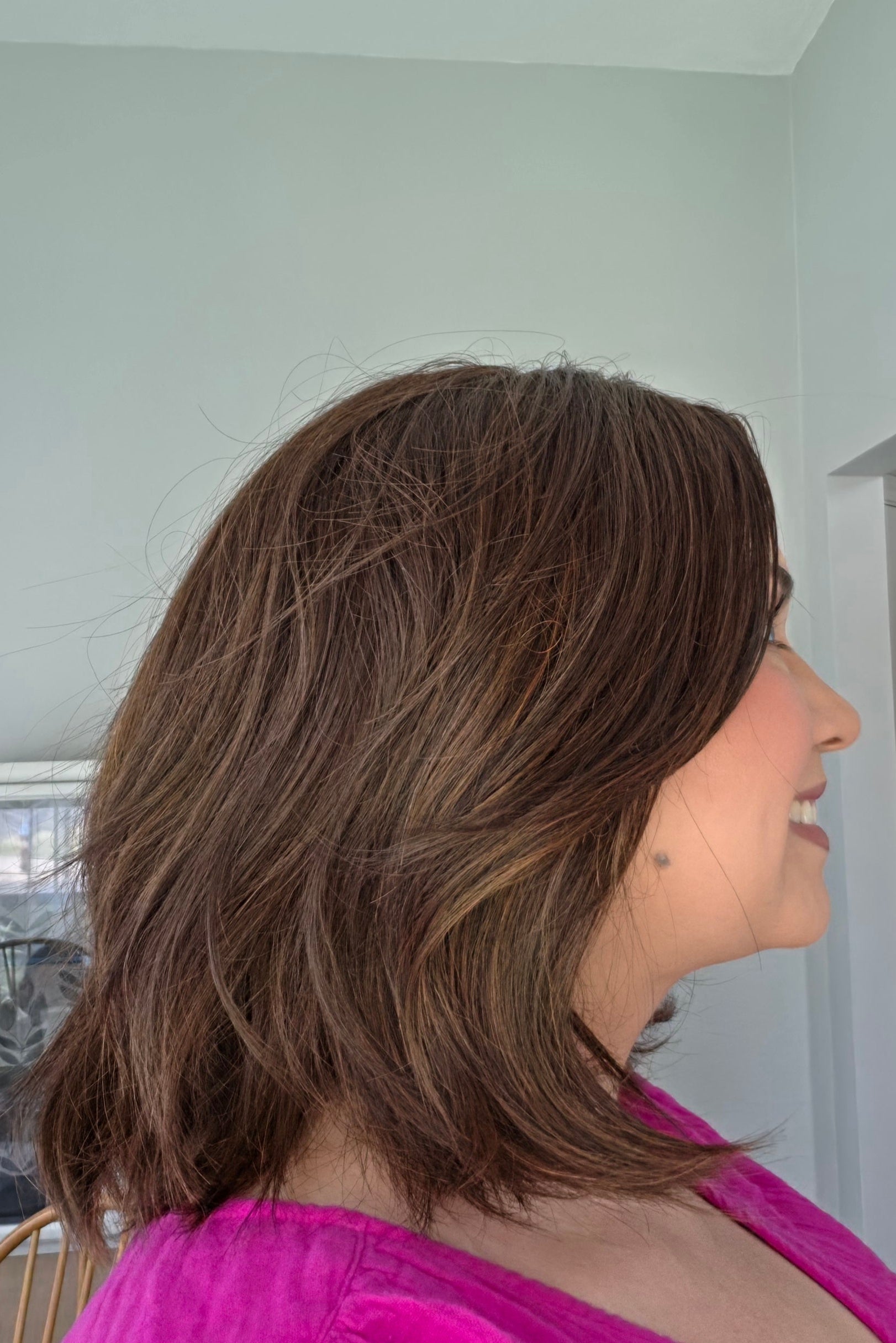 Woman wearing shoulder length wavy bob (Farren by Amore in Ginger Brown).