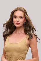 Fiona Lite heat-friendly synthetic wig featuring long, wavy brown layers and a natural lace front hairline.