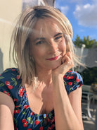 Woman wearing layered shoulder length style wig (Ellen Wille's Flow in Pearl Blonde R)