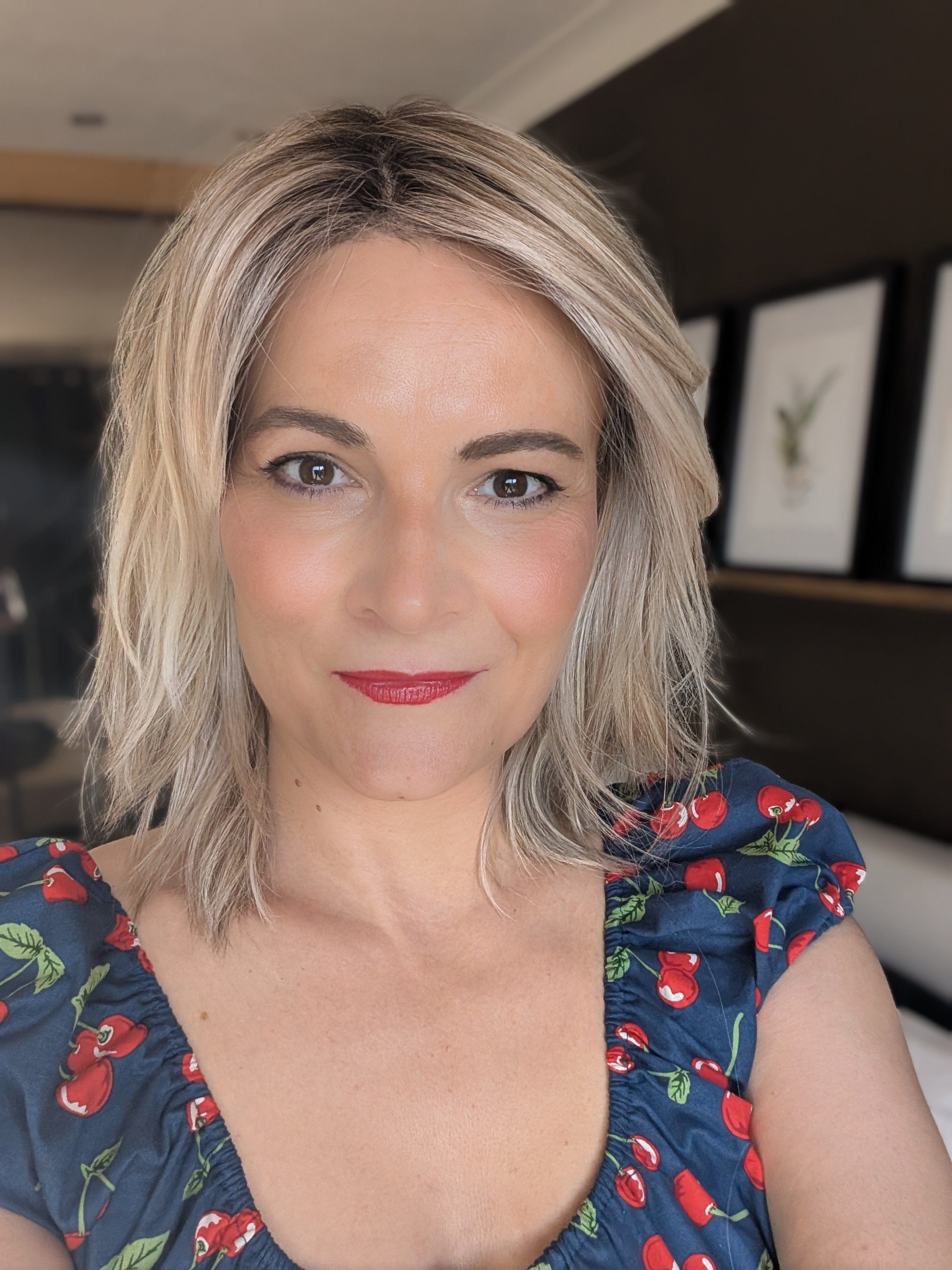 Woman wearing layered shoulder length style wig (Ellen Wille's Flow in Pearl Blonde R)