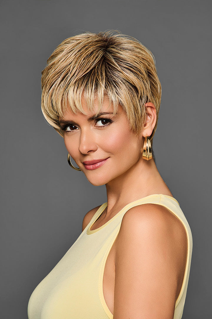 Model wearing a short, layered blonde pixie cut synthetic lace front wig by Gabor with a natural-looking hairline.