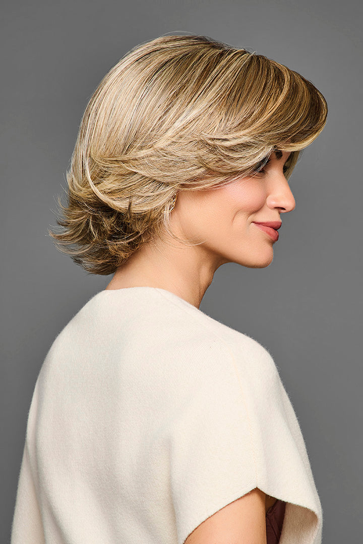 Side profile of a blonde layered bob synthetic wig with a natural lace front and monofilament part.