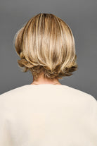 Back view of a layered blonde synthetic bob wig with flipped ends and natural movement.