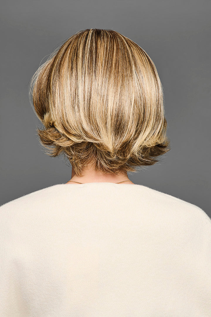 Back view of a layered blonde synthetic bob wig with flipped ends and natural movement.