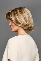 Side profile of a blonde layered bob synthetic wig with a natural lace front and monofilament part.