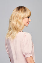 Woman is wearing Aspiration wig by Gabor in SS Light Blonde | Right Side
