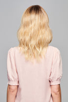 Woman is wearing Aspiration wig by Gabor in SS Light Blonde | Back