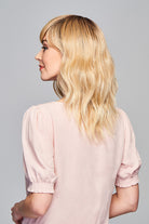 Woman is wearing Aspiration wig by Gabor in SS Light Blonde | Left Side