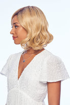 Woman wearing Exhilaration wig by Gabor in  SS Medium Blonde | Left Side