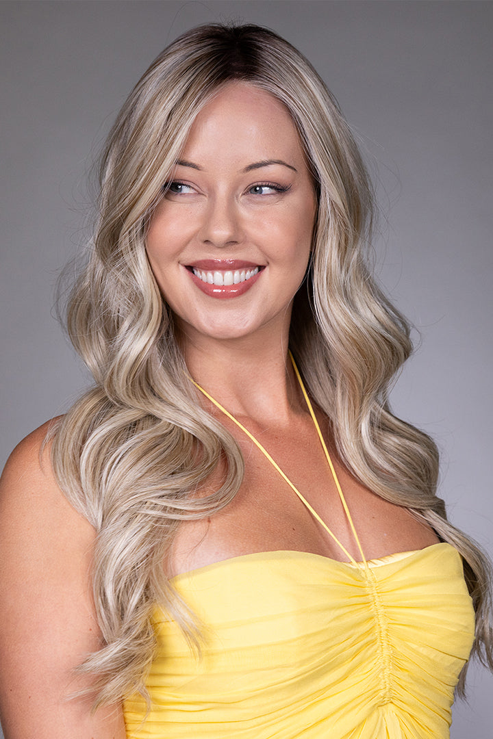 Gisele by Belle Tress long blonde wavy synthetic lace front wig with a natural monofilament top.