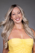 Gisele by Belle Tress long blonde wavy synthetic wig with a natural lace front and monofilament top.