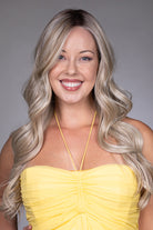 Gisele by Belle Tress long blonde wavy synthetic wig with a natural lace front and monofilament top.