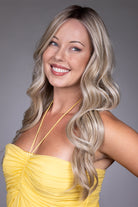 Gisele by Belle Tress long blonde wavy synthetic wig with a natural lace front and monofilament top.