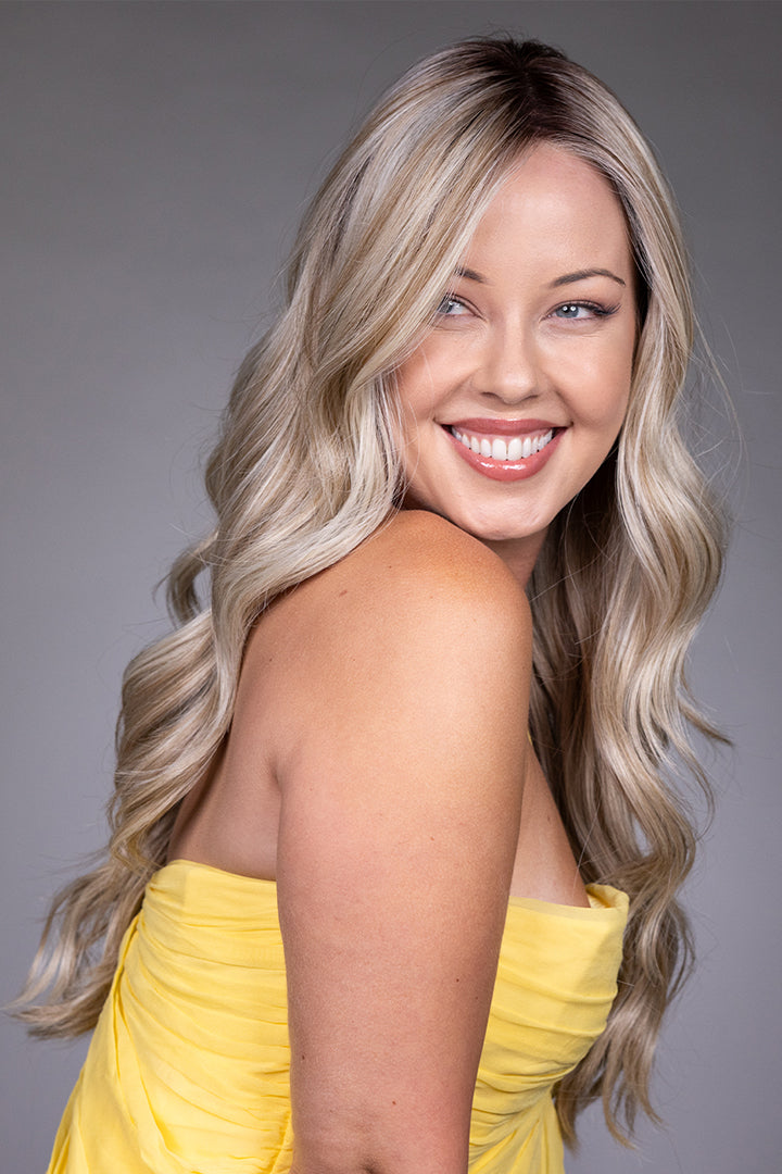 Gisele by Belle Tress long blonde wavy synthetic wig with a natural lace front and monofilament top.