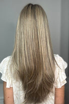 Woman wearing long layered platinum wig (Stay Out Late by Gabor in Shaded Cappuccino)