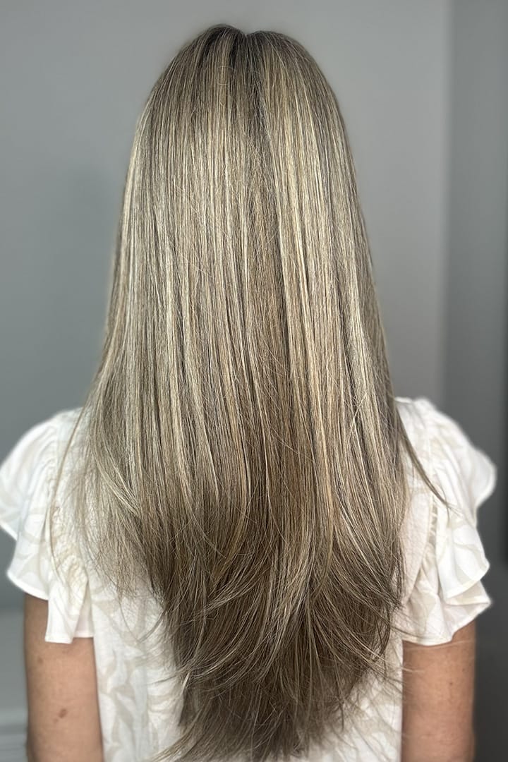 Woman wearing long layered platinum wig (Stay Out Late by Gabor in Shaded Cappuccino)