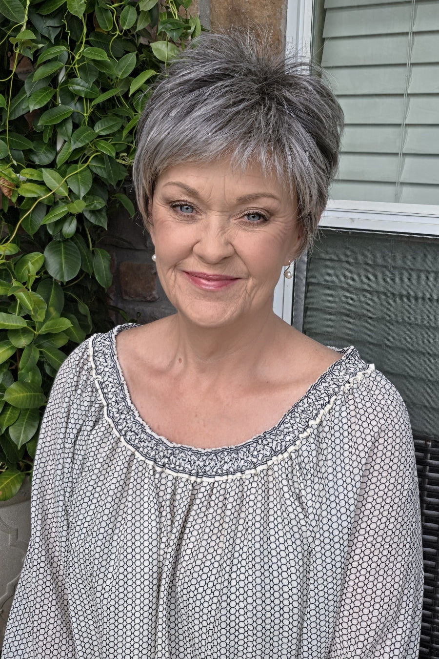 A woman with short gray pixie wig (Boss Energy by Gabor in color Sugar and Charcoal).