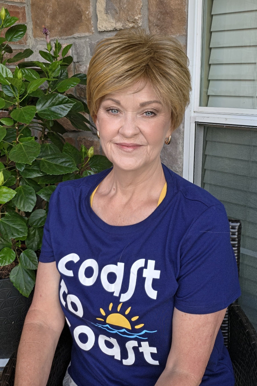 Woman wearing short pixie wig (Friendship by Gabor in color Dark Blonde). 