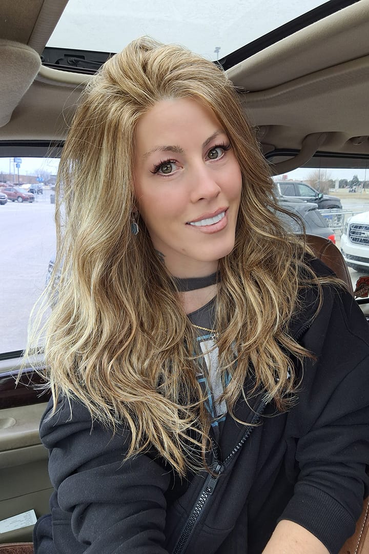 Woman wearing long blonde layered wig (Sweetly Subtle by Gabor in color  Honey Pecan)