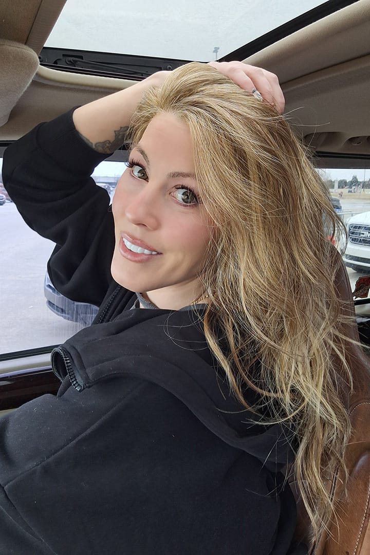 Woman wearing long blonde layered wig (Sweetly Subtle by Gabor in color  Honey Pecan)