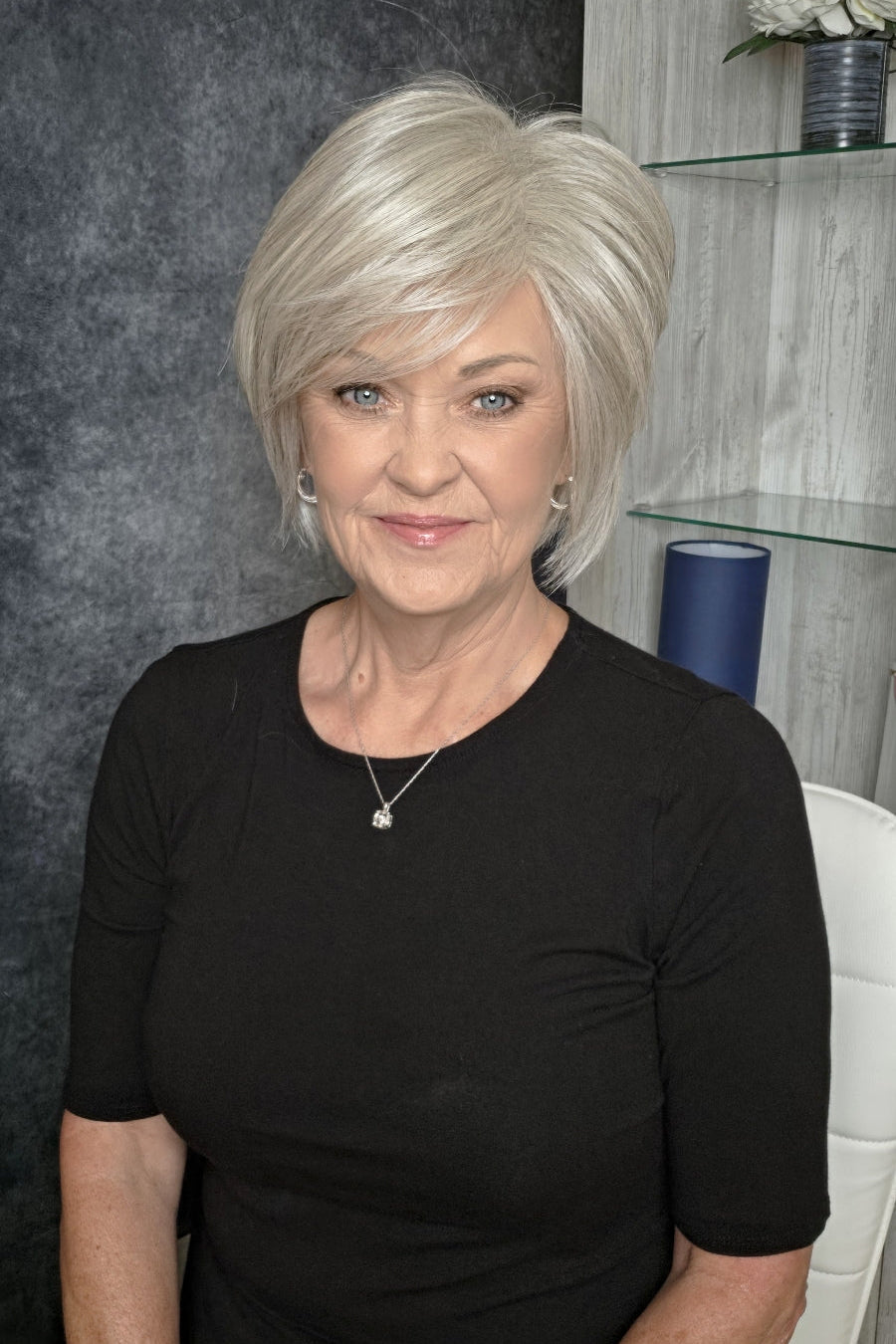 Woman with chin-length blonde bob wig (Wonderful Wit by Gabor in Light Gray).