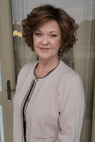 Woman wearing short brunette bob wig (Gabor's Buoyant in color SS Hazelnut)
