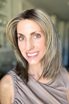 Woman wearing shoulder-length straight wig (Serving Looks by Gabor in color Iced Cafe Latte).