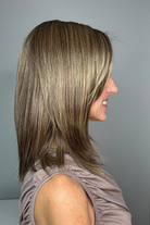 Woman wearing shoulder-length straight wig (Serving Looks by Gabor in color Iced Cafe Latte).