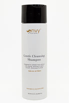 A white bottle of Envy Gentle Cleansing Shampoo with a black flip-top cap, shown against a plain white background.