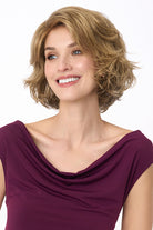 Gia Mono by Envy wavy blonde bob wig with a natural lace front and monofilament top on a smiling woman.