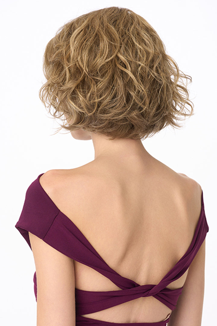 Back view of the Gia Mono synthetic wavy bob wig in a light brown shade with natural volume and texture.